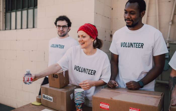 Three People Donating Goods