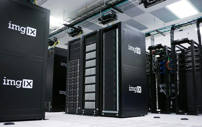 Rows of black server racks with white logos in a data center